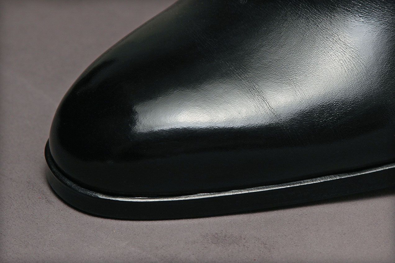 A sewing method used to prevent the soles from extending beyond the contours of the shoes. The thread is hidden deep in the insole.
